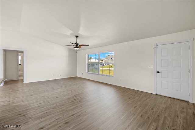 unfurnished living room with ceiling fan, hardwood / wood-style flooring, and vaulted ceiling