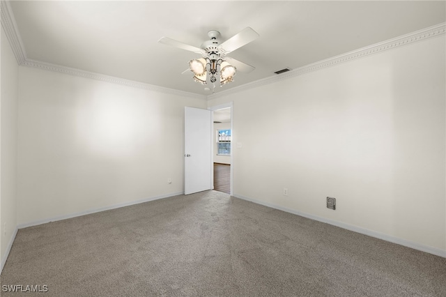 carpeted empty room featuring ceiling fan and ornamental molding