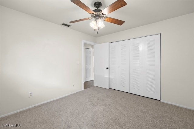 unfurnished bedroom featuring light carpet, a closet, and ceiling fan