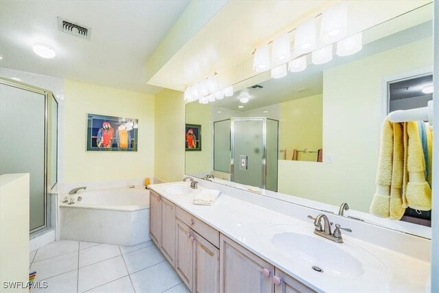 133 Vintage Bay Dr Unit 16, Marco Island, FL 34145 - bathroom featuring a stall shower, a garden tub, double vanity, and tile patterned floors