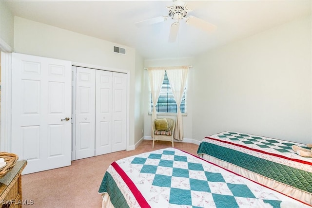 carpeted bedroom with ceiling fan and a closet