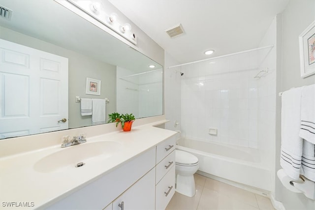 full bathroom featuring toilet, tiled shower / bath combo, vanity, and tile patterned floors