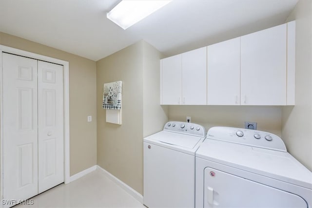 laundry area featuring cabinets and washer and clothes dryer