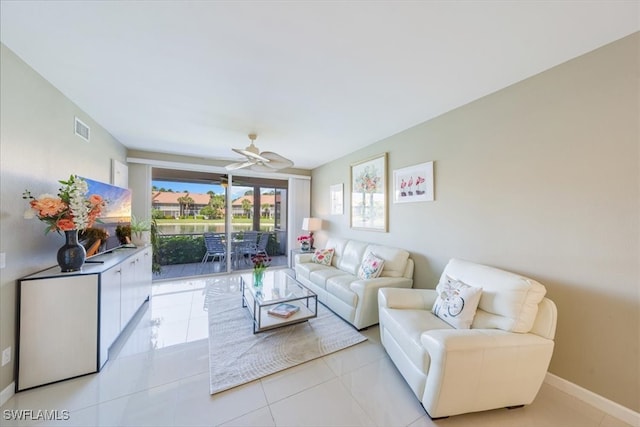 living room featuring ceiling fan and light tile patterned flooring