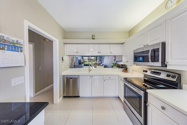 kitchen with white cabinetry, light tile patterned floors, stainless steel appliances, and sink