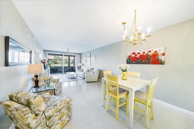 tiled dining area with ceiling fan with notable chandelier