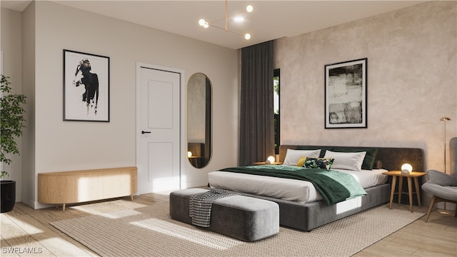 bedroom featuring light hardwood / wood-style floors and a chandelier