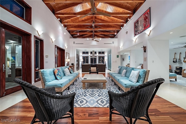 living room with beamed ceiling, wood ceiling, and high vaulted ceiling