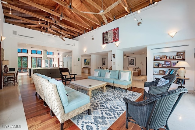 living room with hardwood / wood-style floors, beamed ceiling, wood ceiling, and high vaulted ceiling