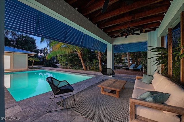 view of pool featuring ceiling fan, an outdoor living space, and a patio area