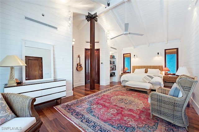 bedroom with high vaulted ceiling, beamed ceiling, wooden walls, and dark hardwood / wood-style floors