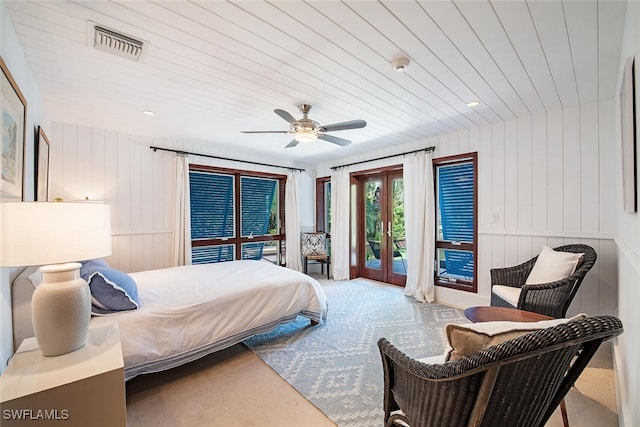 bedroom featuring french doors, access to exterior, wood walls, wooden ceiling, and ceiling fan