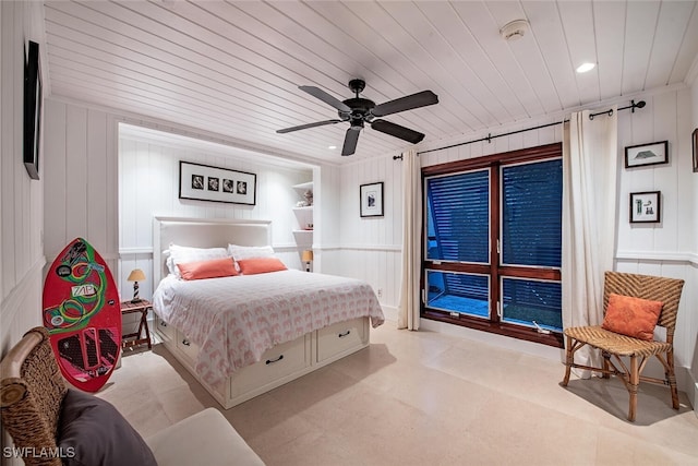 bedroom with wood walls, ceiling fan, and wood ceiling