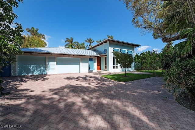 view of front of house with a garage and a front yard