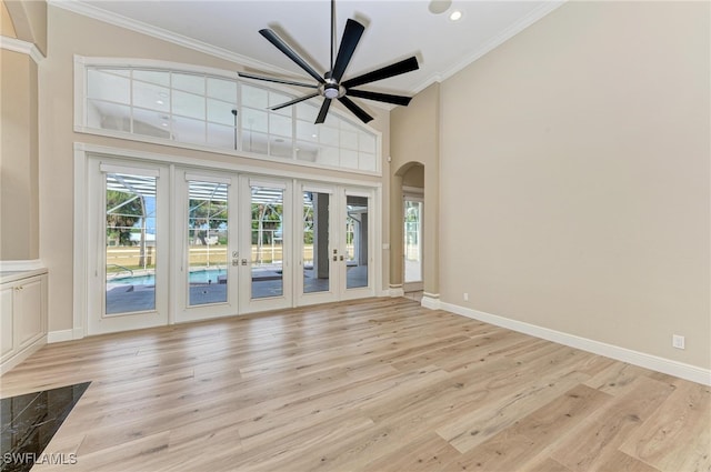 unfurnished living room with ornamental molding, french doors, light hardwood / wood-style floors, and ceiling fan