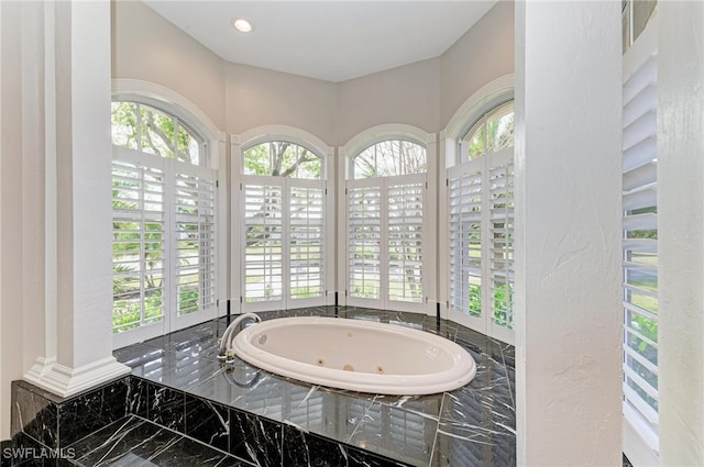 bathroom featuring tiled bath