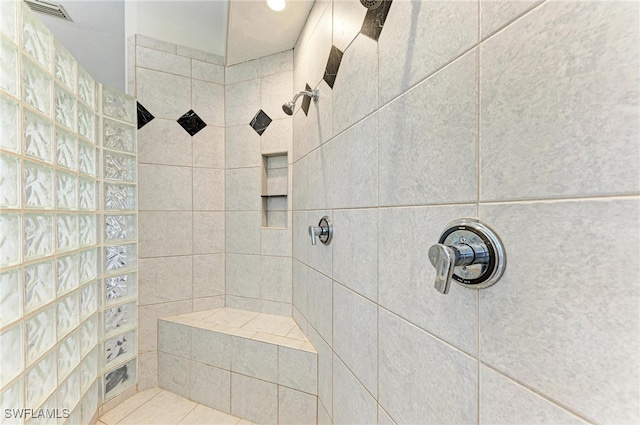 bathroom featuring a tile shower