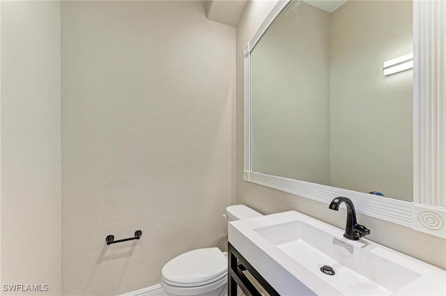 bathroom featuring toilet and vanity