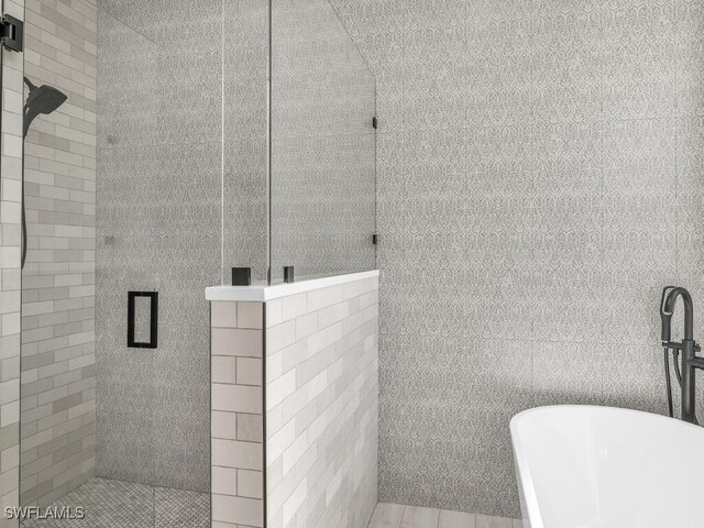 bathroom with separate shower and tub