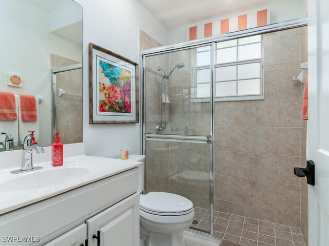 bathroom featuring vanity, toilet, and walk in shower