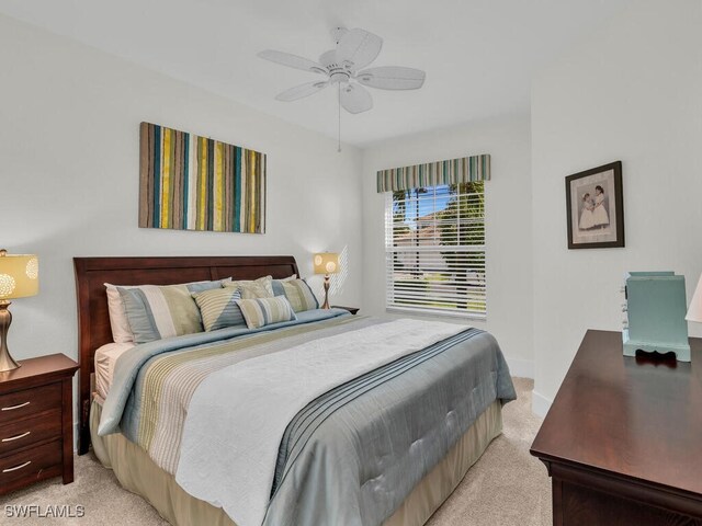 bedroom with light colored carpet and ceiling fan