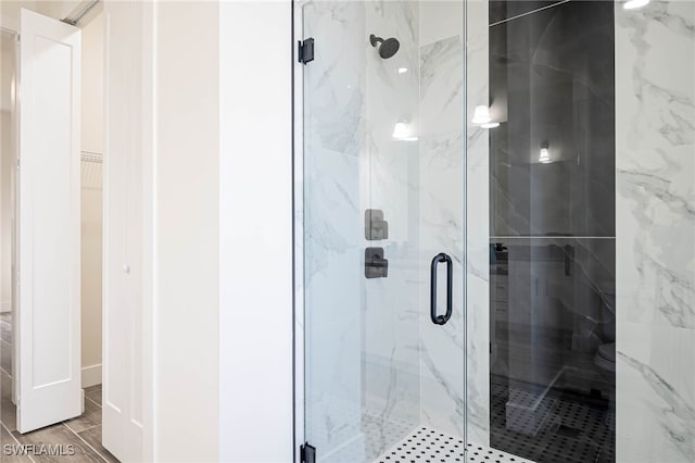 bathroom featuring a shower with shower door