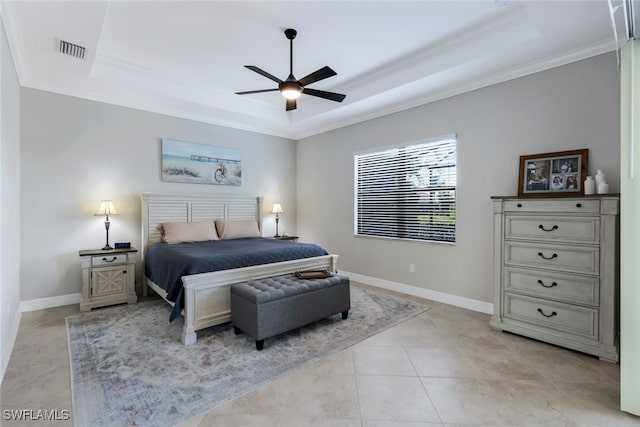 tiled bedroom with ornamental molding, a tray ceiling, and ceiling fan