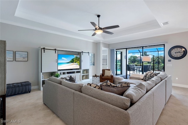 living room featuring ceiling fan, a raised ceiling, and light tile patterned floors