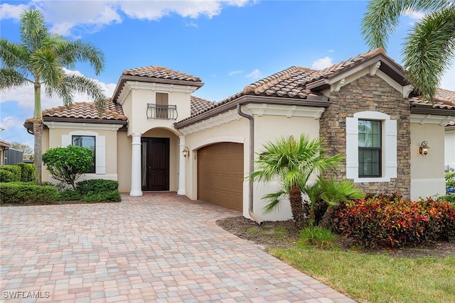 mediterranean / spanish-style house with a garage