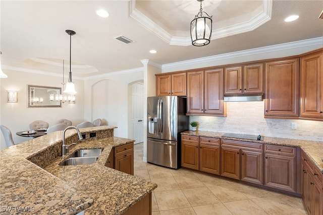 kitchen with stainless steel refrigerator with ice dispenser, a tray ceiling, backsplash, ornamental molding, and sink