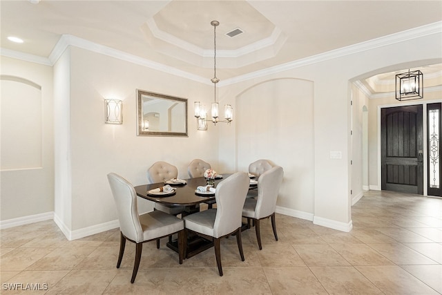 dining room with an inviting chandelier, ornamental molding, and light tile patterned floors