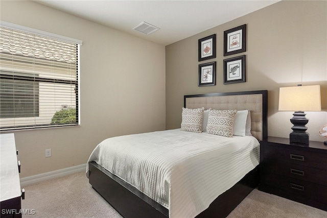 bedroom featuring light colored carpet