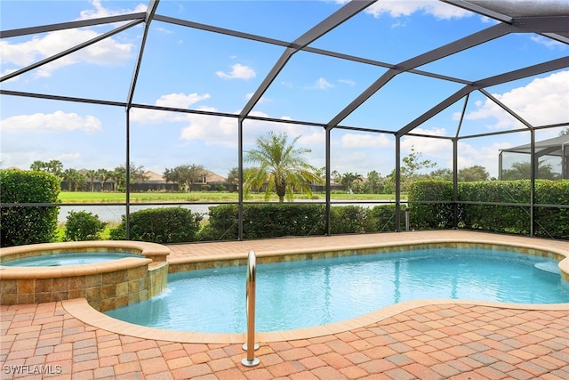 view of pool with an in ground hot tub, a patio area, and glass enclosure