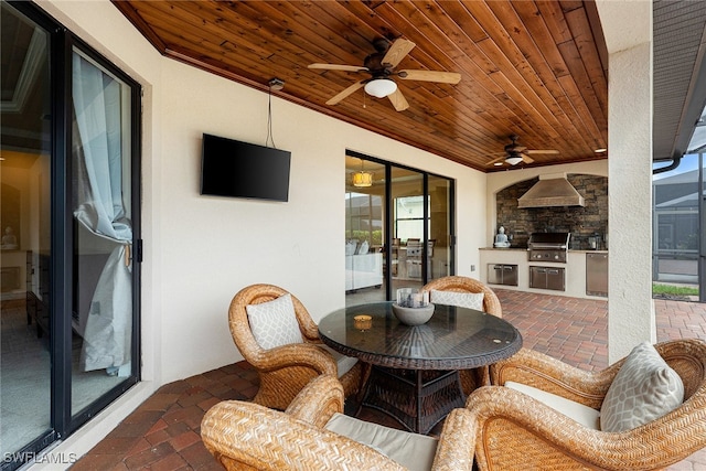 view of patio with ceiling fan, a grill, and exterior kitchen