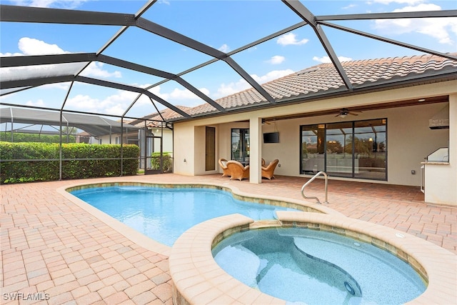 view of swimming pool with an in ground hot tub, a patio area, glass enclosure, and ceiling fan