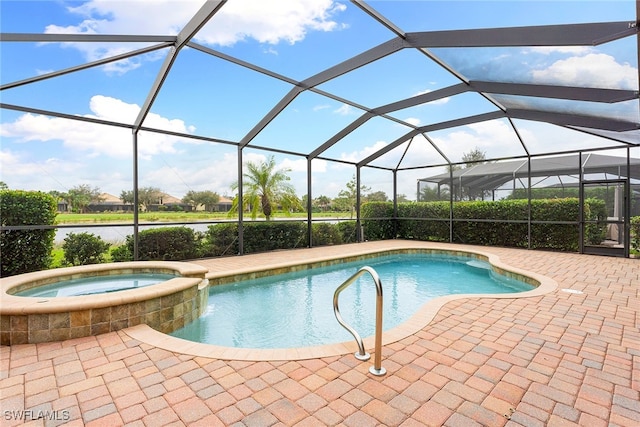 view of pool with a patio, a lanai, and an in ground hot tub