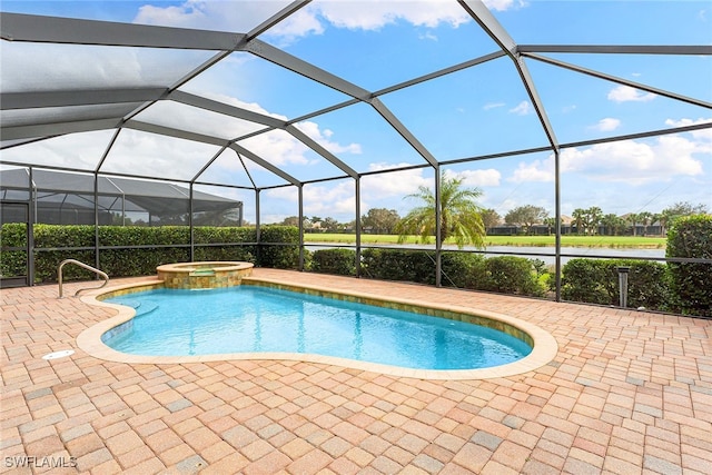 view of pool featuring a patio area, an in ground hot tub, and glass enclosure