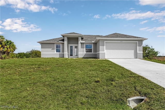 prairie-style home with a front yard and a garage