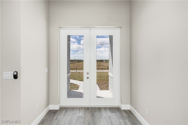 entryway with light hardwood / wood-style flooring and french doors