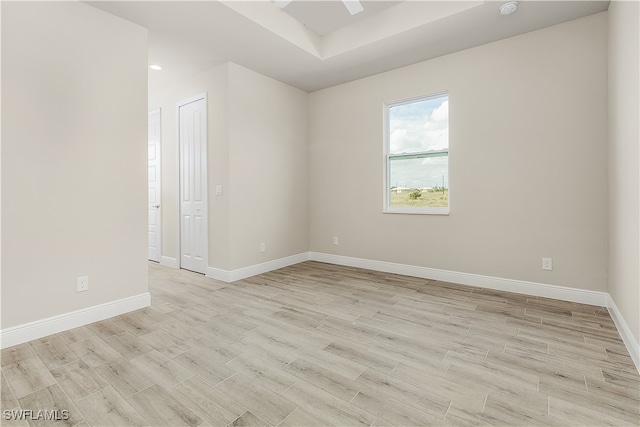 spare room featuring light hardwood / wood-style flooring and ceiling fan