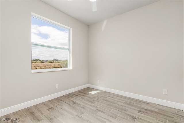 empty room with light hardwood / wood-style floors and ceiling fan