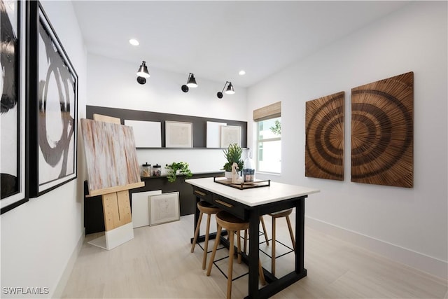 dining space with recessed lighting, baseboards, and light wood-type flooring