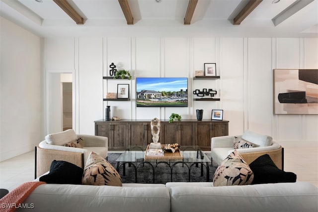 living area with beam ceiling and a decorative wall