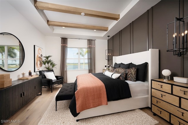 bedroom with beam ceiling and light wood-type flooring