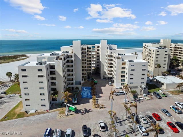 drone / aerial view with a water view and a beach view