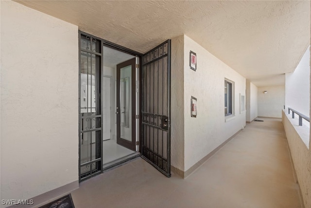 hallway with a textured ceiling