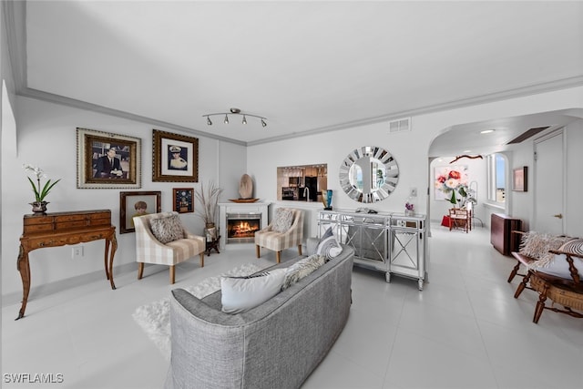 tiled living room featuring crown molding