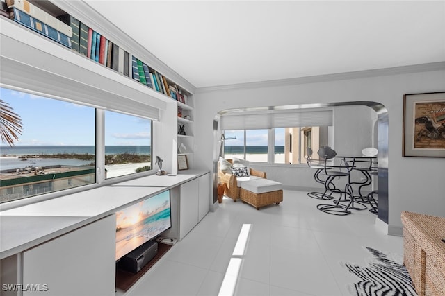 living room with a water view, light tile patterned floors, and plenty of natural light