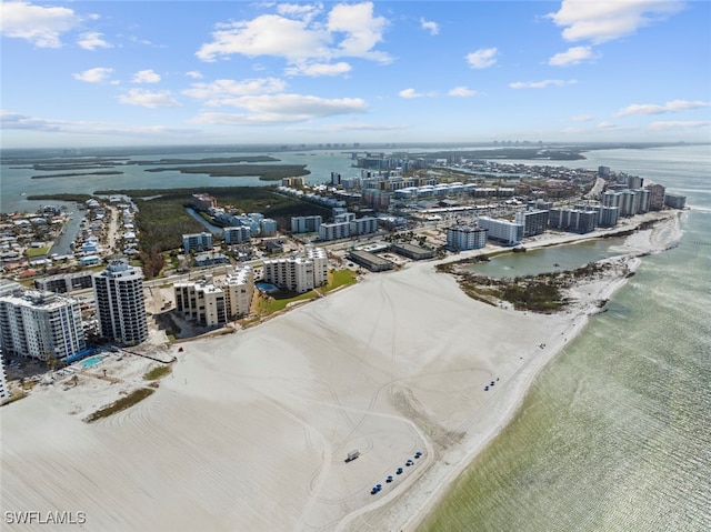 bird's eye view with a water view and a beach view