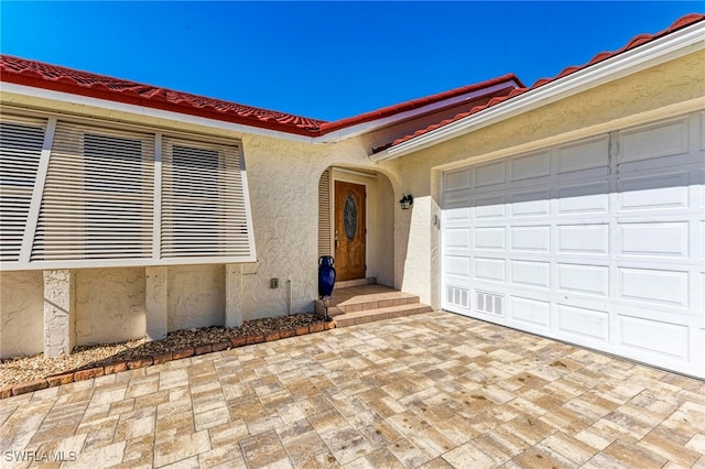 doorway to property featuring a garage